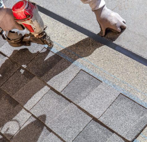 A roofer installing a roof with the newest roofing techniques and tools